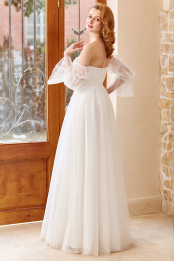 Ein schulterfreies weißes Brautkleid mit langen Ärmeln